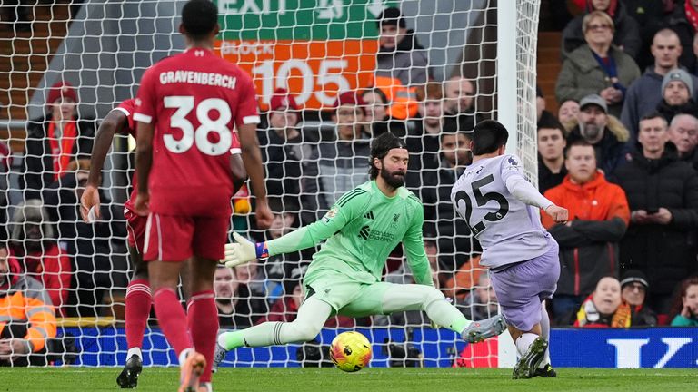 Alisson keeps out Diego Gomez one-on-one in the first half at Anfield