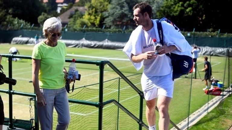 Andy Murray and his mum Judy Murray leave the practice courts after he finishes his session on day four of the Wimbledon Championships at th