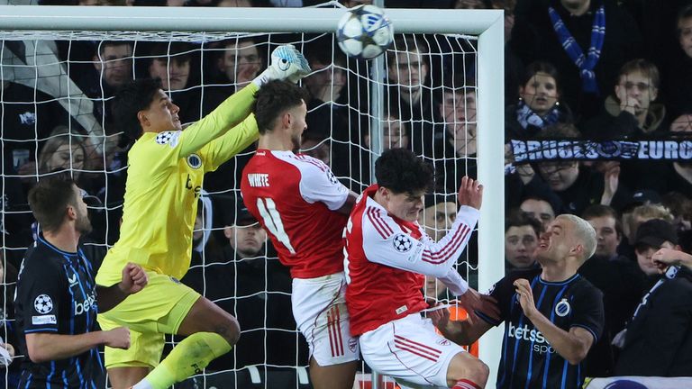 Brugge's goalkeeper Tristan van den Heuvel, second left, goes up for a save against Arsenal's Ben White, center, during the Champions League opening phase soccer match between Club Brugge and Arsenal in Bruges, Belgium, Wednesday, Dec. 10, 2025. (AP Photo/Omar Havana)