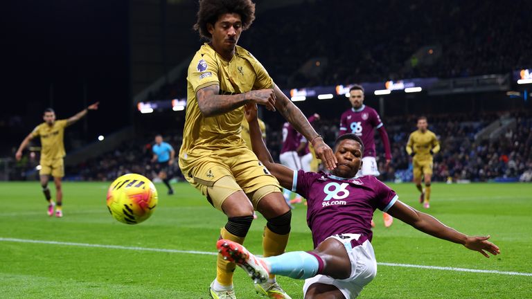 Chris Richards of Crystal Palace is tackled by Florentino Luis of Burnley