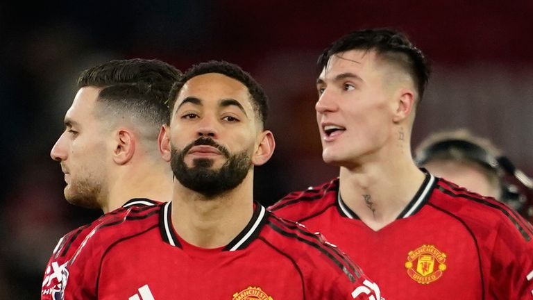 Manchester United's Diogo Dalot, Matheus Cunha and Benjamin Sesko stand on the pitch disappointed after the English Premier League soccer match between Manchester United and Wolverhampton Wanderers in Manchester, England, Tuesday, Dec. 30, 2025. (AP Photo/Dave Thompson)