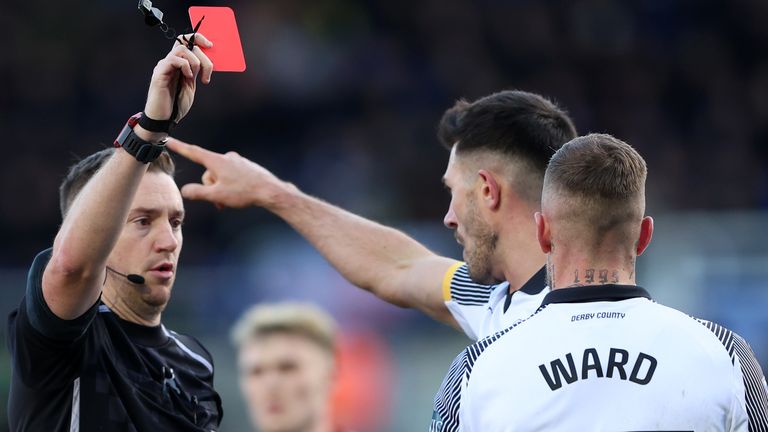 Referee Ben Toner shows a red card to Joe Ward of Derby County 