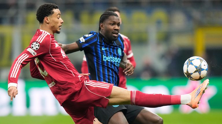 Liverpool's Hugo Ekitike controls the ball next to Inter Milan's Marcus Thuram