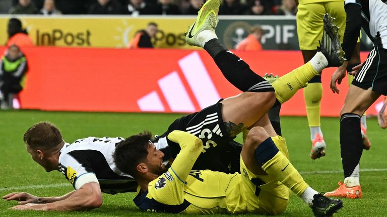 Tottenham Hotspur  midfielder Rodrigo Bentancur fouls Newcastle United's defender Dan Burn for a penalty