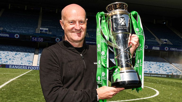 GLASGOW, SCOTLAND - MAY 18: Hibernian Head Coach Grant Scott lifts the Scottish Women's Premier League trophy during a Scottish Women's Premier League match between Rangers and Hibernian at Ibrox Stadium, on May 18, 2025, in Glasgow, Scotland. (Photo by Ross MacDonald / SNS Group)