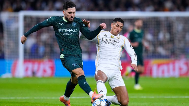 Manchester City's Rayan Cherki, left, vies for the ball with Real Madrid's Jude Bellingham during a Champions League opening phase soccer match between Real Madrid and Manchester City, in Madrid, Spain, Wednesday, Dec. 10, 2025. (AP Photo/Manu Fernandez)