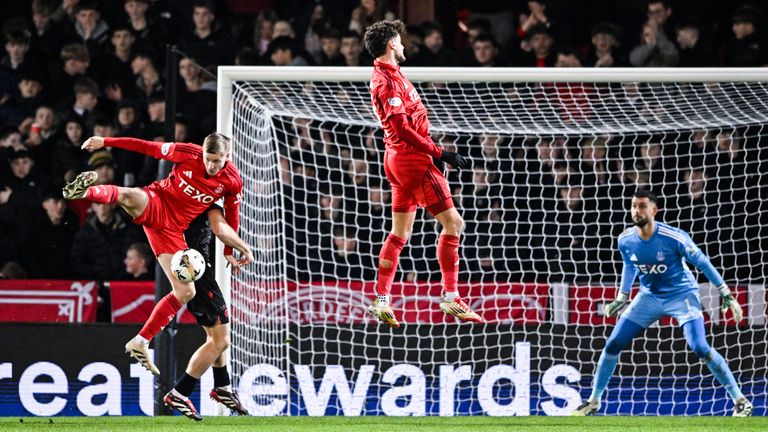 ABERDEEN, SCOTLAND - DECEMBER 03: Aberdeen's Mats Knoester (L) is adjudged to have handled the ball in the box and St Mirren are awarded a penalty following a VAR check during a William Hill Premiership match between Aberdeen and St Mirren at Pittodrie Stadium, on December 03, 2025, in Aberdeen, Scotland. (Photo by Paul Devlin / SNS Group)