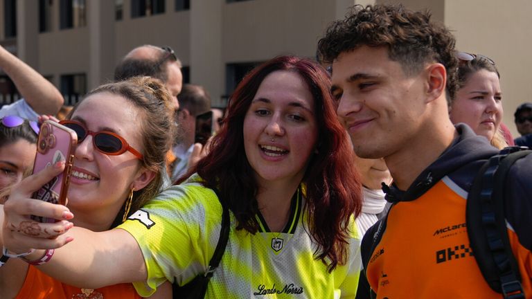 Fans take selfies with McLaren driver Lando Norris of Britain as he arrives at Yas Marina Circuit ahead of the Abu Dhabi Formula One Grand Prix, in Abu Dhabi, United Arab Emirates, Saturday, Dec. 06, 2025. (AP Photo/Altaf Qadri)