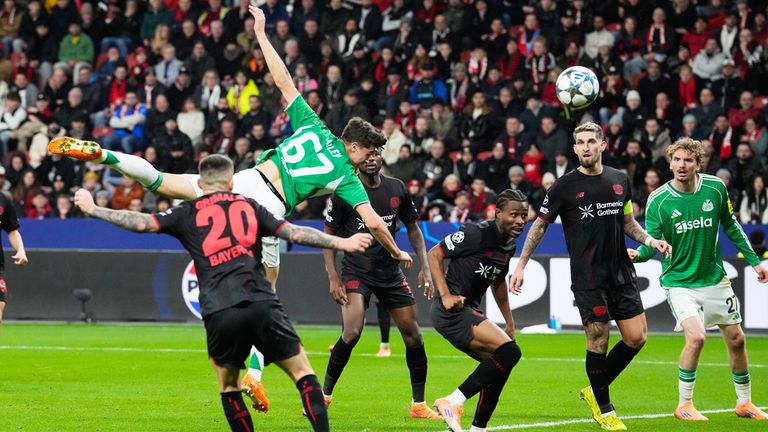 Newcastle's Lewis Miley heads his side's second goal during the Champions League opening phase soccer match between Bayer Leverkusen and Newcastle United in Leverkusen, Germany, Wednesday, Dec. 10, 2025. (AP Photo/Martin Meissner)