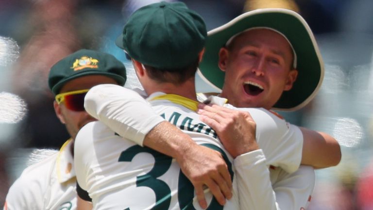 Australia's Marnus Labuschagne, right, and Australia's captain Pat Cummins celebrates the wicket of England's Will Jacks during play on the final day of the third Ashes cricket test between England and Australia in Adelaide, Australia, Sunday, Dec. 21, 2025. (AP Photo/James Elsby)