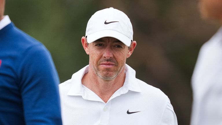Rory McIlroy of Northern Ireland (centre) reacts after completing his round with Adam Scott of Australia (Left) and Min Woo Lee of Australia (Right) during the first round of the Australian Open golf tournament in Melbourne, Australia, Thursday, Dec. 4, 2025. (AP Photo/Asanka Brendon Ratnayake)