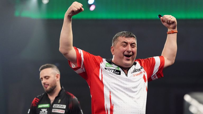 Mensur Suljovic celebrates defeating England's Joe Cullen at the World Darts Championship