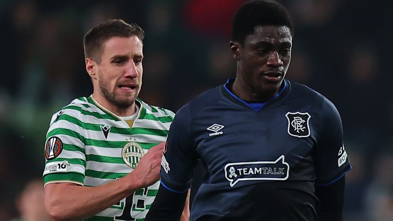 Nasser Djiga of Rangers passes the ball whilst under pressure from Barnabas Varga of Ferencvarosi TC