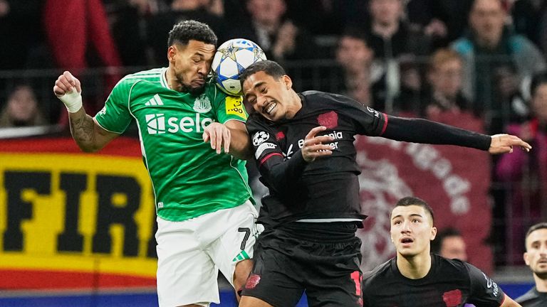 Newcastle's Joelinton, left, and Leverkusen's Arthur jump for the ball during the Champions League opening phase soccer match between Bayer Leverkusen and Newcastle United in Leverkusen, Germany, Wednesday, Dec. 10, 2025. (AP Photo/Martin Meissner)
