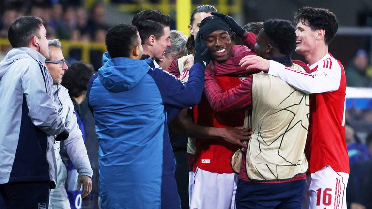 Arsenal's Noni Madueke, center, is congratulated after scoring the opening goal during the Champions League opening phase soccer match between Club Brugge and Arsenal in Bruges, Belgium, Wednesday, Dec. 10, 2025. (AP Photo/Omar Havana)