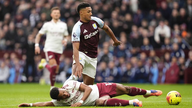 Aston Villa's Ollie Watkins leaves Arsenal's Jurrien Timber on the ground before having a shot saved by David Raya