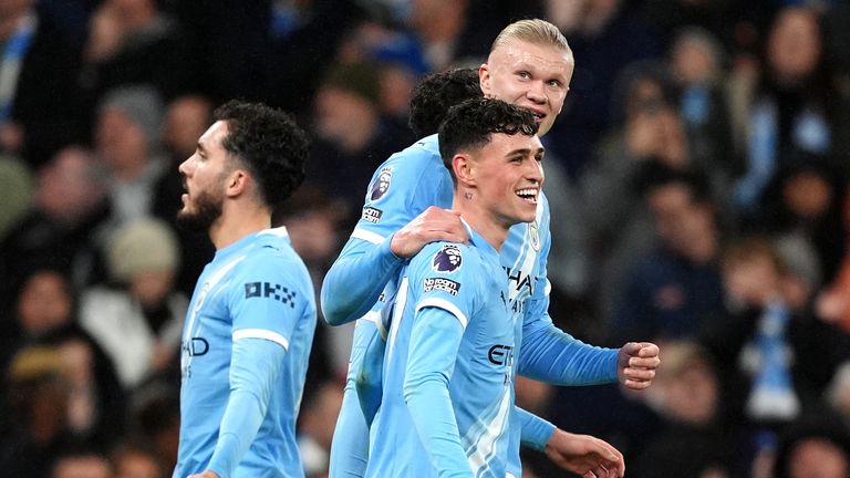 Manchester City's Phil Foden celebrates with Erling Haaland after scoring their third goal of the game