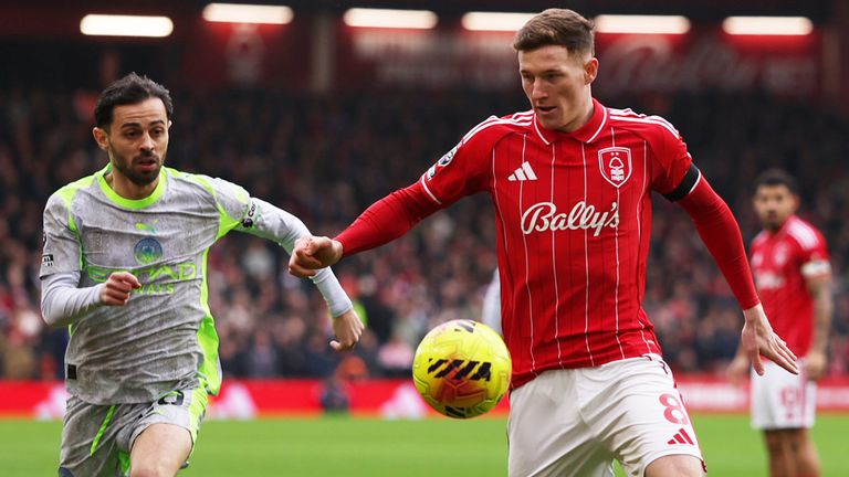Elliot Anderson controls the ball under pressure from Bernardo Silva