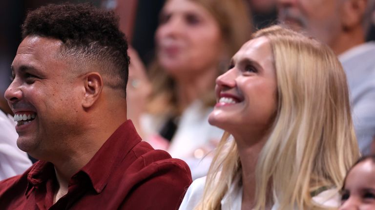 Former footballer Ronaldo and Celina Locks look on courtside as they watch the Battle of the Sexes match between Aryna Sabalenka and Nick Kyrgios, in Dubai, United Arab Emirates, Sunday Dec. 28, 2025. (Christopher Pike/Pool Photo via AP)