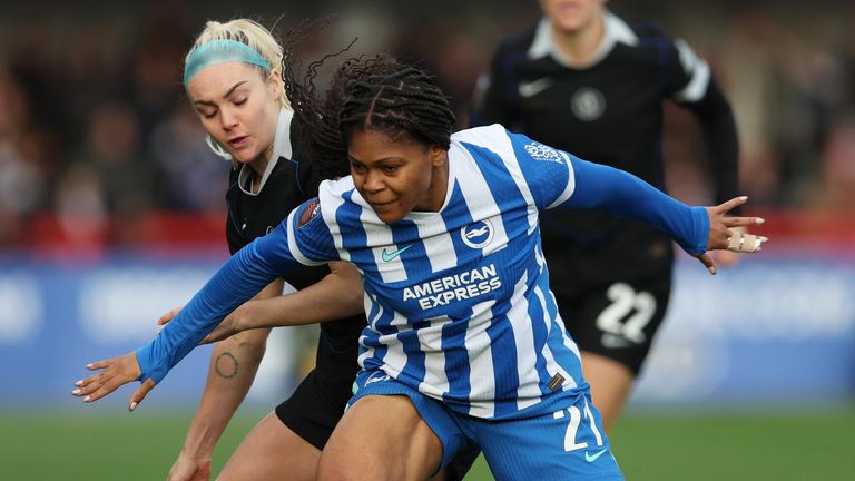 Madison Haley battles for possession with Ellie Carpenter 