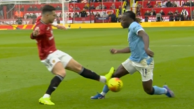 Diogo Dalot only received a yellow card for this challenge on Jeremy Doku