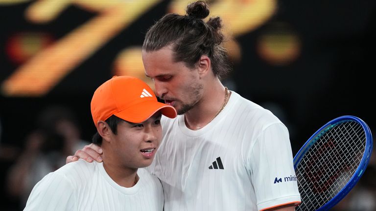 Alexander Zverev, right, of Germany is congratulated by Learner Tien, left, of the U.S. following their quarterfinal match at the Australian