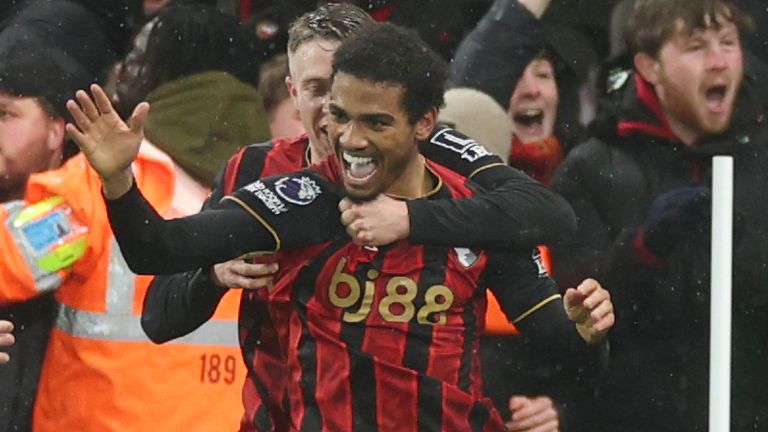 Amine Adli is mobbed by his team-mates after scoring Bournemouth's last-gasp winner against Liverpool