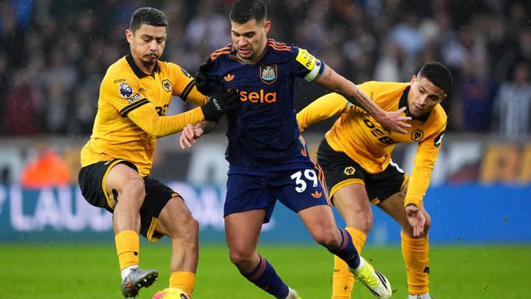 Wolves' Andre and Joao Gomes and Newcastle United's Bruno Guimaraes battle for the ball 