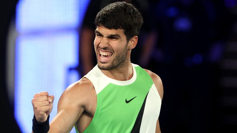 Spain's Carlos Alcaraz reacts on a point to Australia's Alex De Minaur during their men's singles quarter-final match on day ten of the Aust
