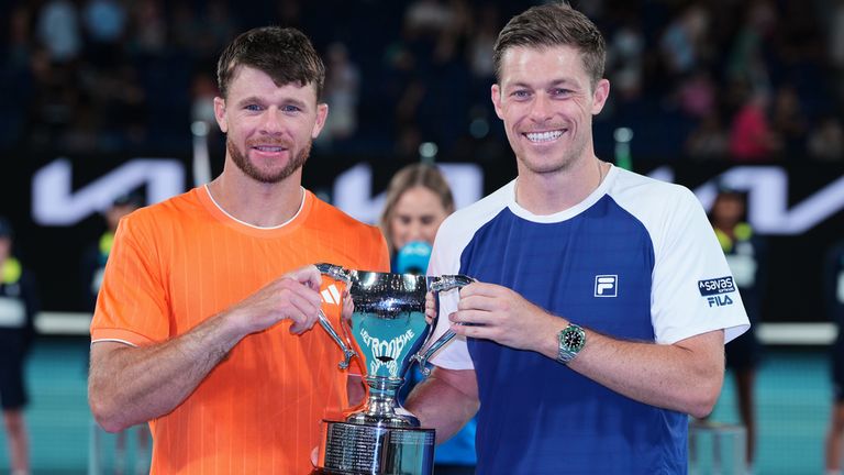 Christian Harrison of the U.S. and Neal Skupski, right, of Britain hold their trophy after defeating Australia's Jason Kubler and Marc Polma