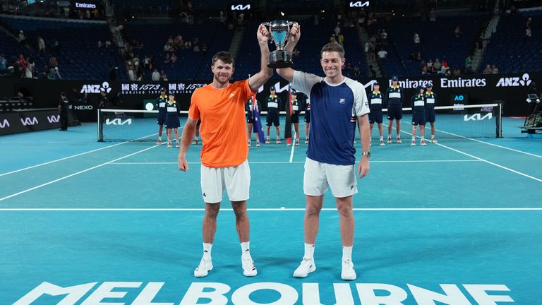 Christian Harrison of the U.S. and Neal Skupski, right, of Britain hold their trophy aloft after defeating Australia's Jason Kubler and Marc