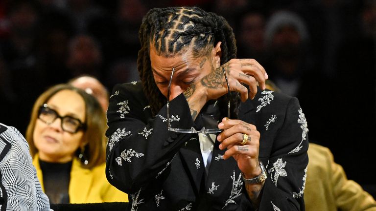 Former Chicago Bulls player Derrick Rose, wipes away tears as former teammates speak during a jersey retirement ceremony (AP)