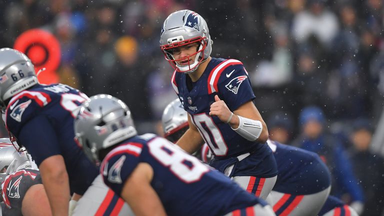 New England Patriots quarterback Drake Maye, top, signals at the line of scrimmage during the first half of an NFL divisional playoff football game against the Houston Texans, Sunday, Jan. 18, 2026, in Foxborough, Mass. (AP Photo/Steven Senne)