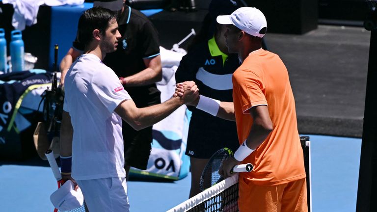 Portugal's Nuno Borges (L) is congratulated by Canada's Felix Auger-Aliassime, who retired from an injury, in their men's singles match on d
