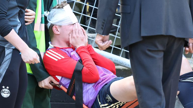 The Aberdeen player was taken off the pitch for treatment