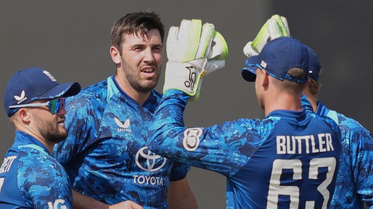 England's Jamie Overton celebrates with teammates the wicket of Sri Lanka's Kamil Mishara during the second ODI (Associated Press) 