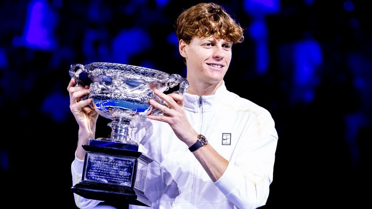 Jannik Sinner raises the Norman Brookes Challenge Cup after winning the Australian Open