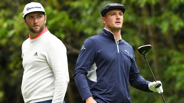 Jon Rahm of Spain (L) and Bryson DeChambeau watch a tee shot on the 12th hole during the second round of the Genesis Open at Riviera Countr