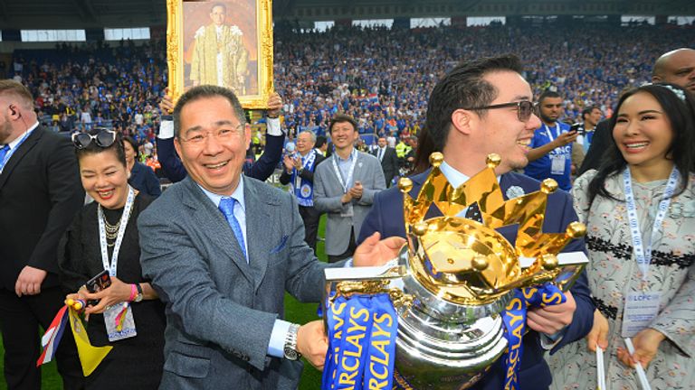 Vichai Srivaddhanaprabha and Aiyawatt hold the Premier League Trophy after Leicester's famous win.
