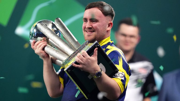 Luke Littler celebrates with the Sid Waddell trophy after victory against Gian van Veen in the World Darts Championship final