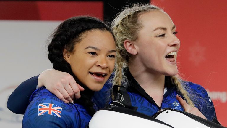 Mica Moore (L) and Mica McNeill (R) of Britain after their final heat during the women's two-man bobsled final at the 2018 Winter Olympics