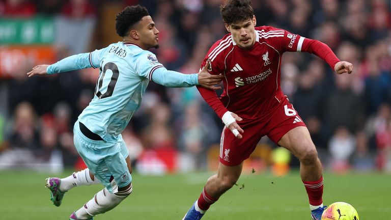 Milos Kerkez of Liverpool is challenged by Marcus Edwards of Burnley