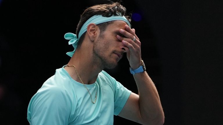 Lorenzo Musetti of Italy reacts as he withdraws from his quarterfinal match against Novak Djokovic of Serbia at the Australian Open tennis championship in Melbourne, Australia, Wednesday, Jan. 28, 2026. (AP Photo/Asanka Brendon Ratnayake)