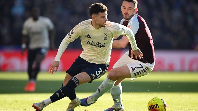 Neco Williams of Nottingham Forest is challenged by John McGinn of Aston Villa