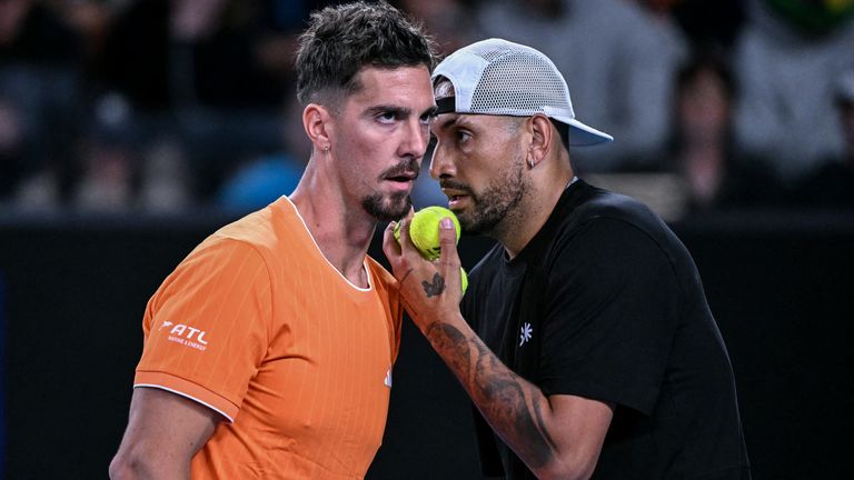 Australia's Thanasi Kokkinakis (L) and Nick Kyrgios speak during their men's doubles match against compatriot Jason Kubler and Marc Polmans 