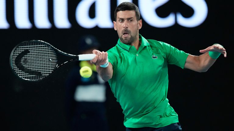 Novak Djokovic of Serbia plays a forehand return to Pedro Martinez of Spain during their first round match at the Australian Open tennis championship in Melbourne, Australia, Monday, Jan. 19, 2026. (AP Photo/Aaron Favila)
