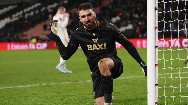 Matt Ingram celebrates saving MK Dons' fifth penalty