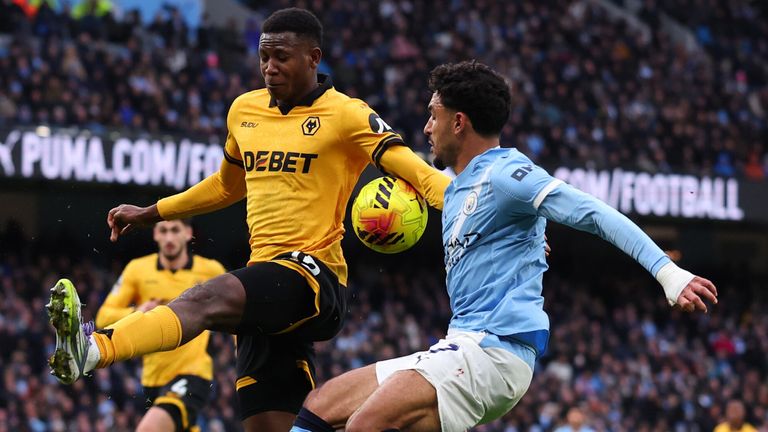 Yerson Mosquera appears to handle the ball after a touch by Omar Marmoush 