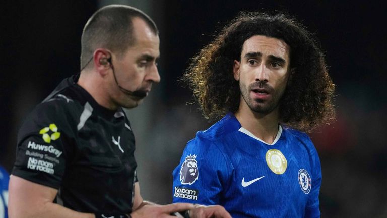 Marc Cucurella speaks with referee Peter Bankes after being show a red card