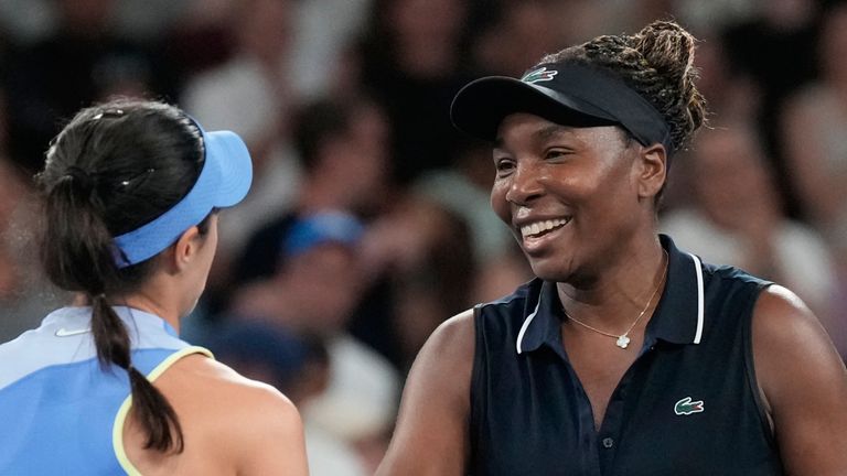 Olga Danilovic, left, of Serbia is congratulated by Venus Williams of the U.S. following their first round match at the Australian Open tennis championship in Melbourne, Australia, Sunday, Jan. 18, 2026. (AP Photo/Aaron Favila)